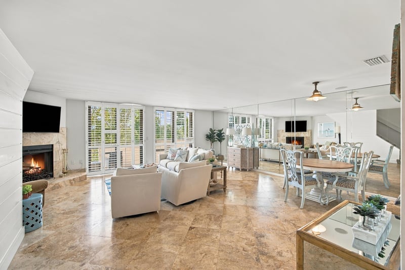 Living and dining room with fireplace and tile floor at 752 Spinnakers Reach Dr, Ponte Vedra Beach, FL 32082