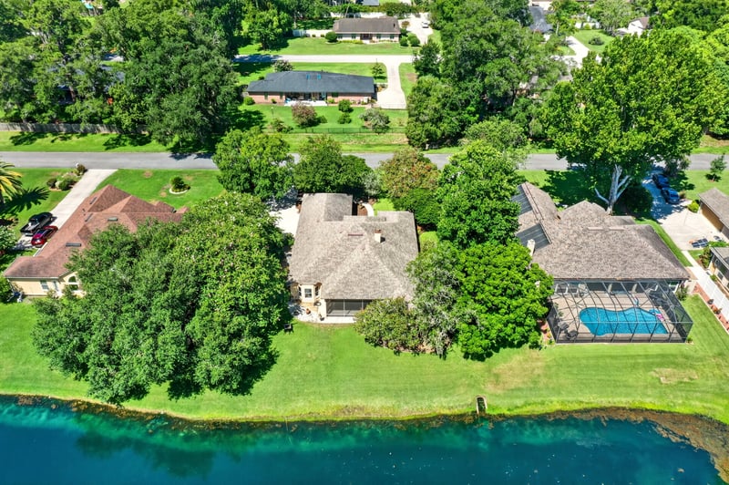 Wide aerial of the neighborhood pond and homes in Jacksonville, FL