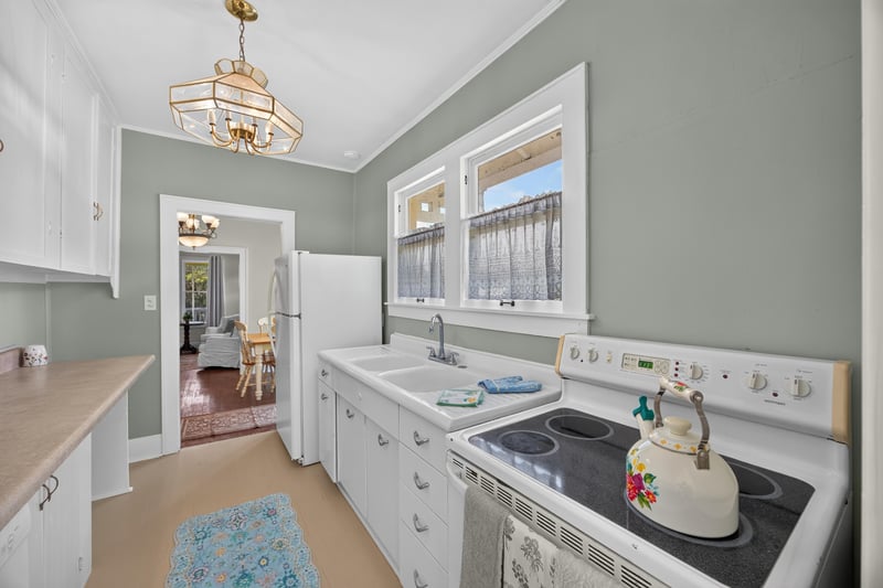 Kitchen with green walls and white cabinets at 101 N Lake St, Crescent City, FL