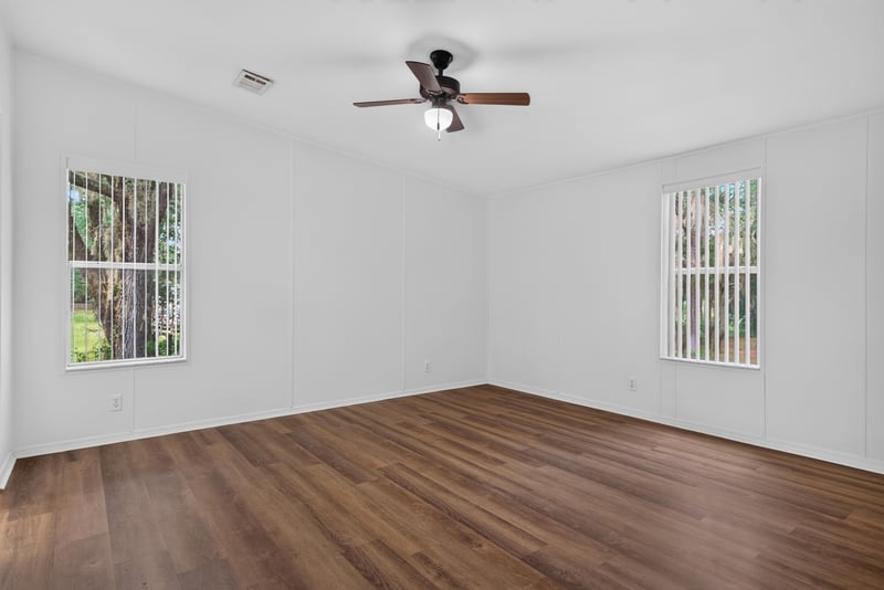 Bedroom with two windows and wood flooring at 3215 Robin Ln, Middleburg, FL