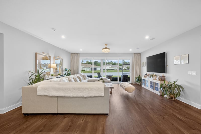Bedroom with sitting area and wall mounted TV at 85491 Fall River Pkwy, Fernandina Beach, FL 32034