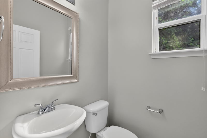 Bathroom with pedestal sink and mirror at 13685 Goodson Pl, Jacksonville, FL 32226