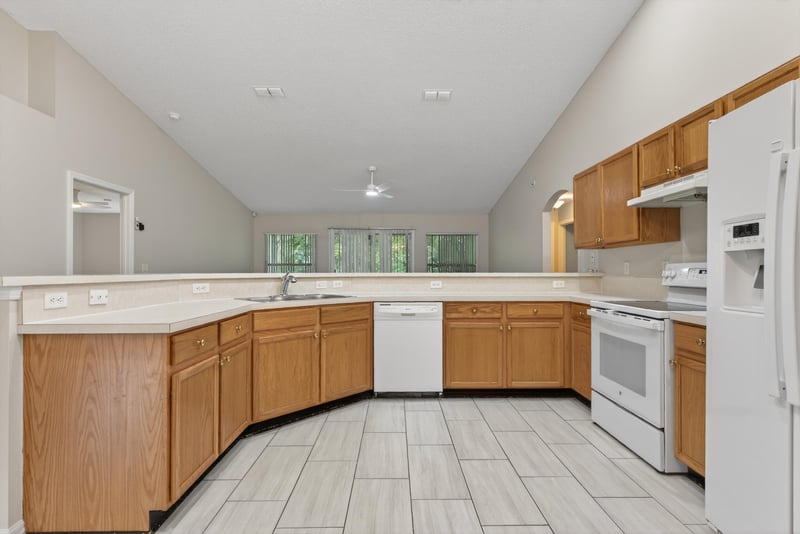 Kitchen with wood cabinets and tile floor at 1648 Glen Laurel Dr, Middleburg, FL 32068