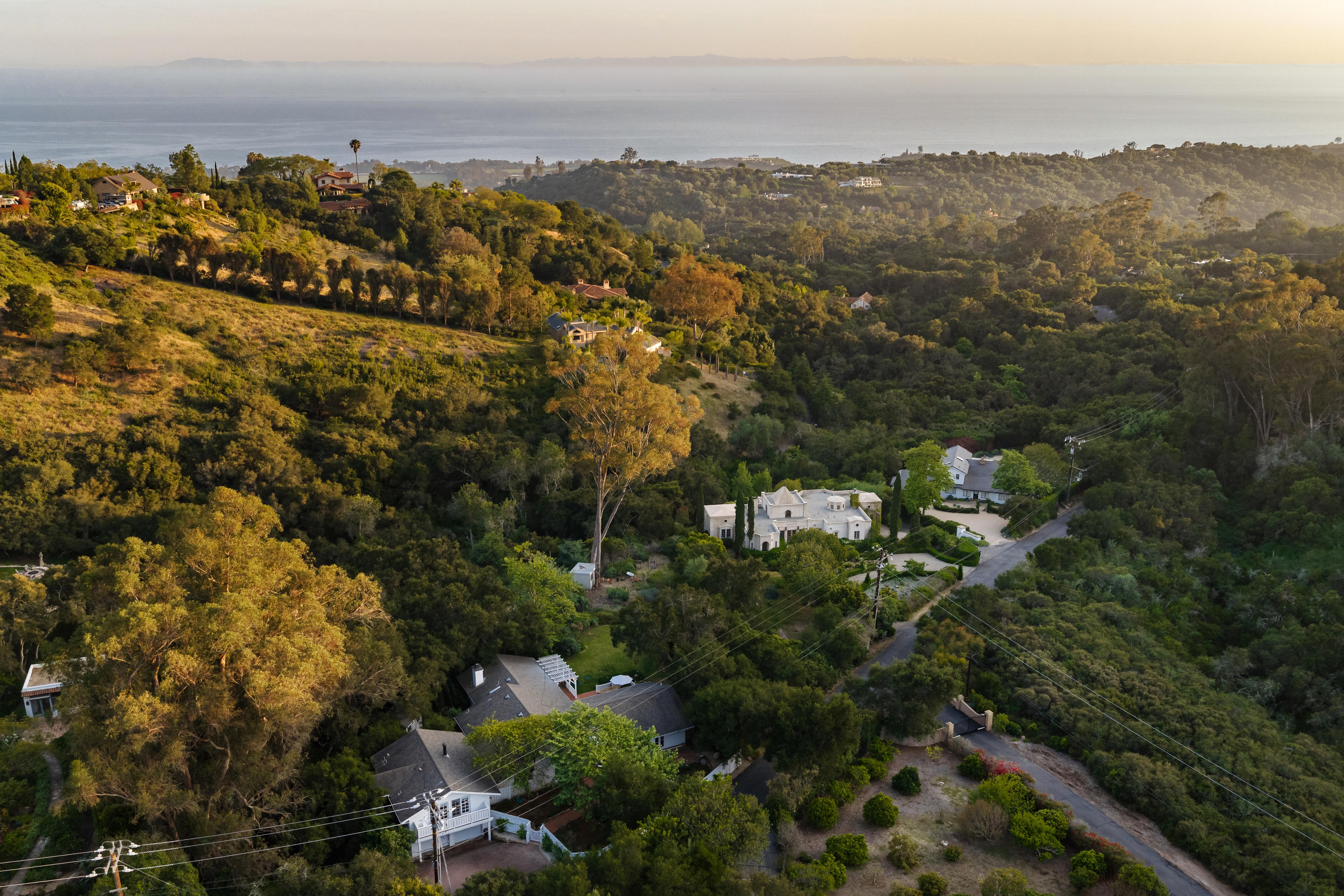Aerial drone photography of 2915 Hidden Valley Ln, Santa Barbara CA — sweeping elevated perspective reveals the property's relationship to the surrounding Montecito foothills and mature tree canopy in this real estate drone photography series by VirTour Media. Our team captured still photography, aerial drone photography, and twilight photography from late afternoon through twilight.
