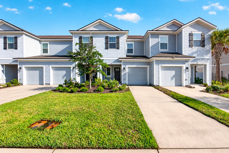 Front exterior with two-car garage and lawn at 339 Anthony Dr, Jacksonville, FL