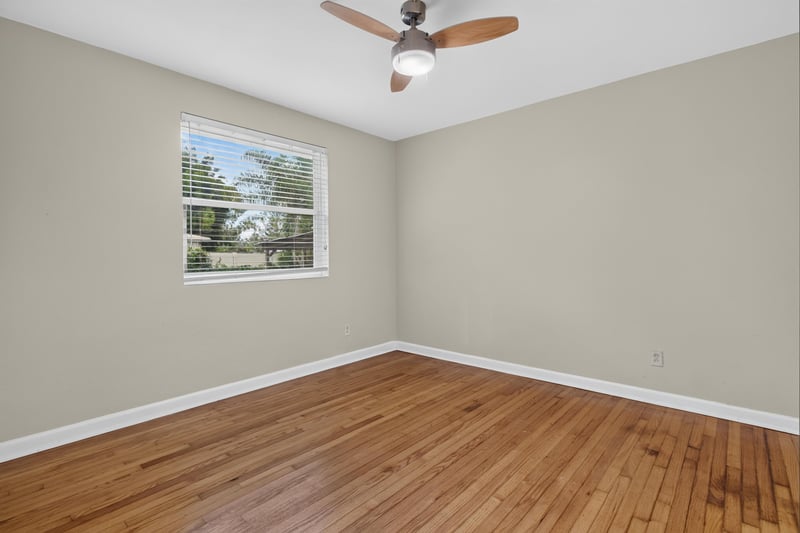 Bedroom with wood floors and window at 217 Baisden Rd, Jacksonville, FL 32218