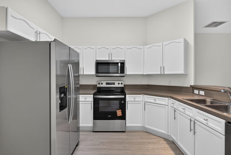 Kitchen with stainless refrigerator and white cabinets at 706 Bonaparte Dr, Jacksonville, FL 32218