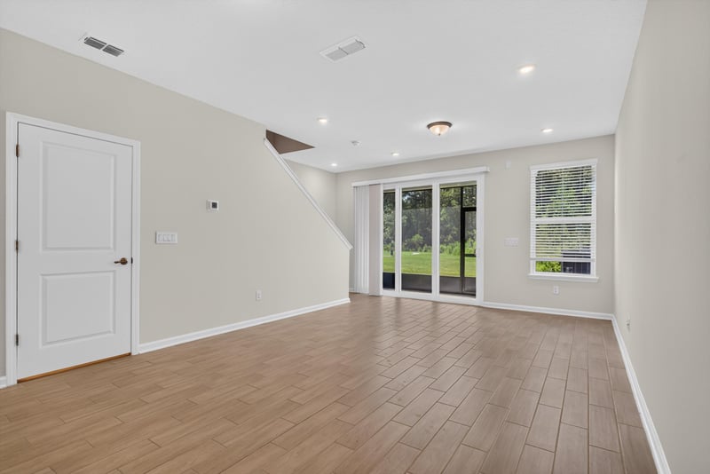 Living room with sliding glass doors and wood floor at 39 Mellowood Ln, St. Augustine, FL 32092