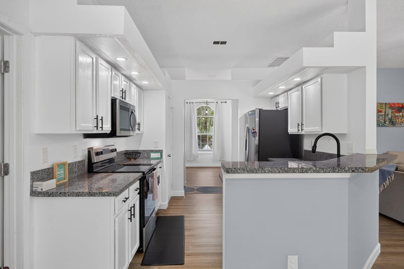 Kitchen with stainless appliances and granite counters at 8921 Needlepoint Pl, Jacksonville, FL 32244