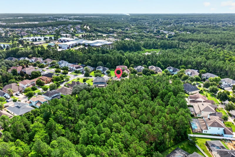 Aerial view of neighborhood with pond in distance in Ponte Vedra Beach, FL