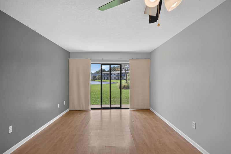 Living room with curtains and wood-look flooring at 700 W Pope Rd unit h61, St. Augustine, FL 32080