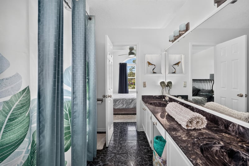 Bathroom vanity with dark countertop at 1346 Gately Ct, Jacksonville, FL 32225