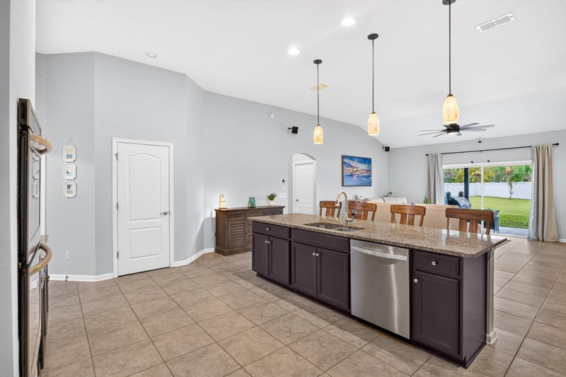 Kitchen with stainless refrigerator and pendant lights at 538 Porta Rosa Circle, St. Augustine, FL 32092