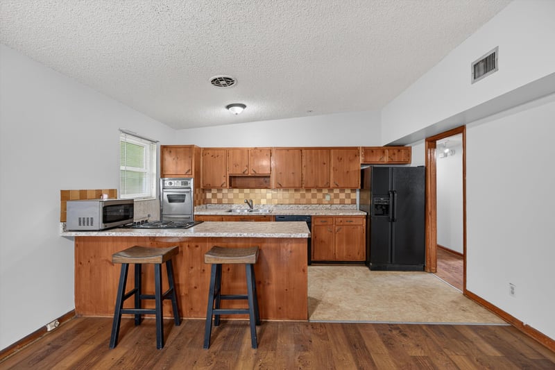 Kitchen with bar stools and wood cabinets at 11462 Elane Dr, Jacksonville, FL
