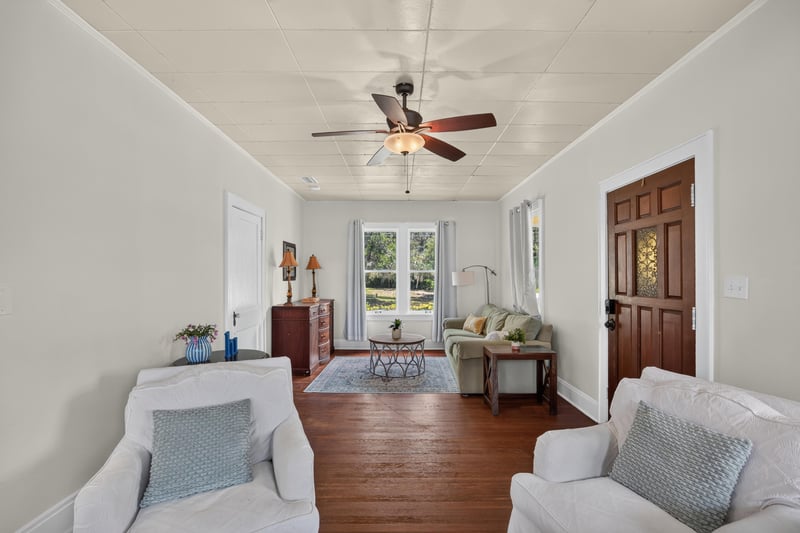 Living room with wood floors and doorway at 101 N Lake St, Crescent City, FL