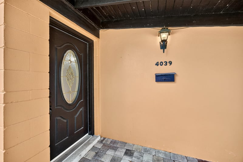 Front door with address numbers and tiled entry at 4039 Habana Ave, Jacksonville, FL