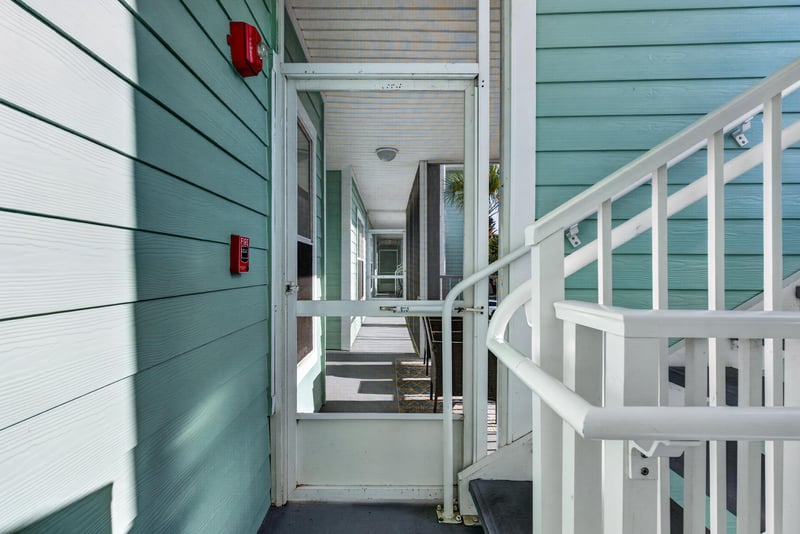 Covered entry stairwell leading to the unit door at 206 16th St, St. Augustine, FL 32080