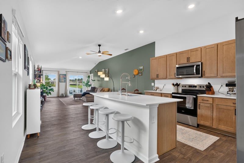 Kitchen with white island and stainless appliances at 4276 Quaking St, Jacksonville, FL 32218