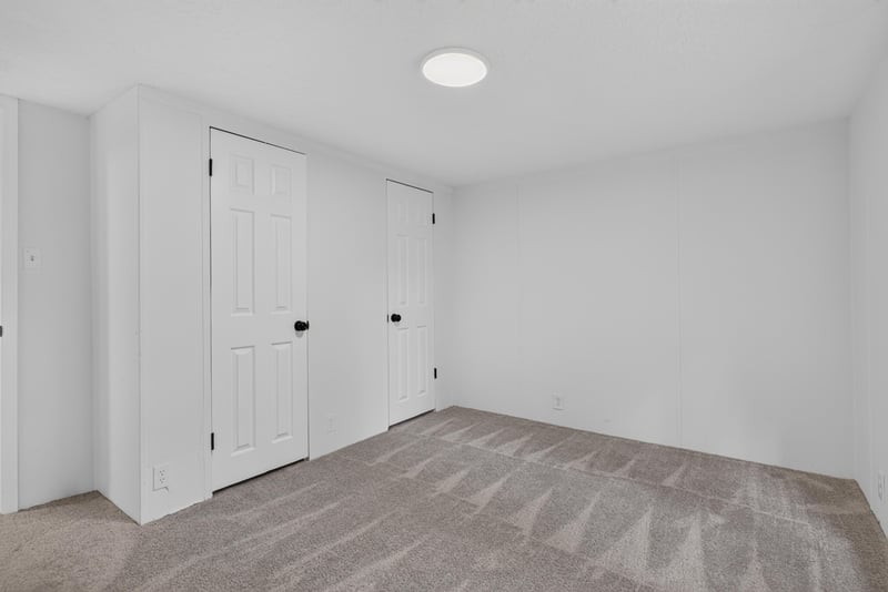 Bedroom with carpet and closet doors at 55520 Jewel-Thomas Rd, Callahan, FL 32011