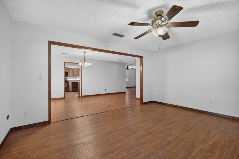 Open living and dining area with wood floors and archway at 892 Branscomb Rd, Green Cove Springs, FL
