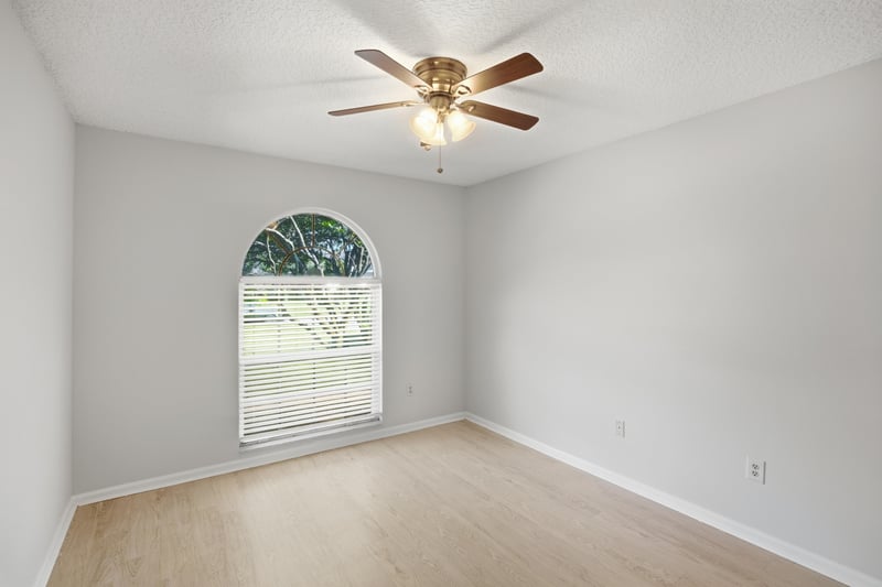 Bedroom with arched window at 678 5th Ave N, Jacksonville Beach, FL 32250