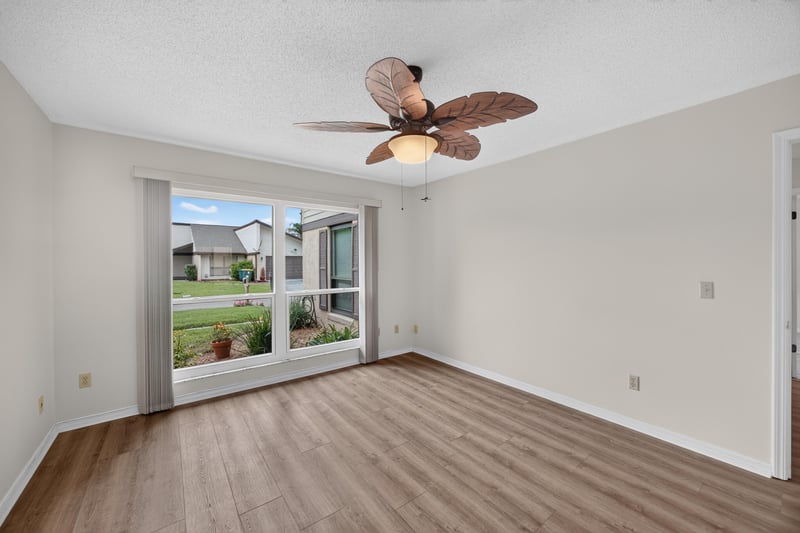 Staged bedroom with ceiling fan and windows at 3407 Fairbanks Grant Rd N, Jacksonville, FL 32223