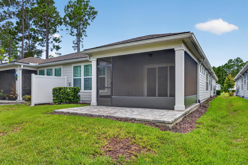 Rear exterior with screened lanai and side yard at 171 Oyster Shell Ter, Nocatee, FL 32081