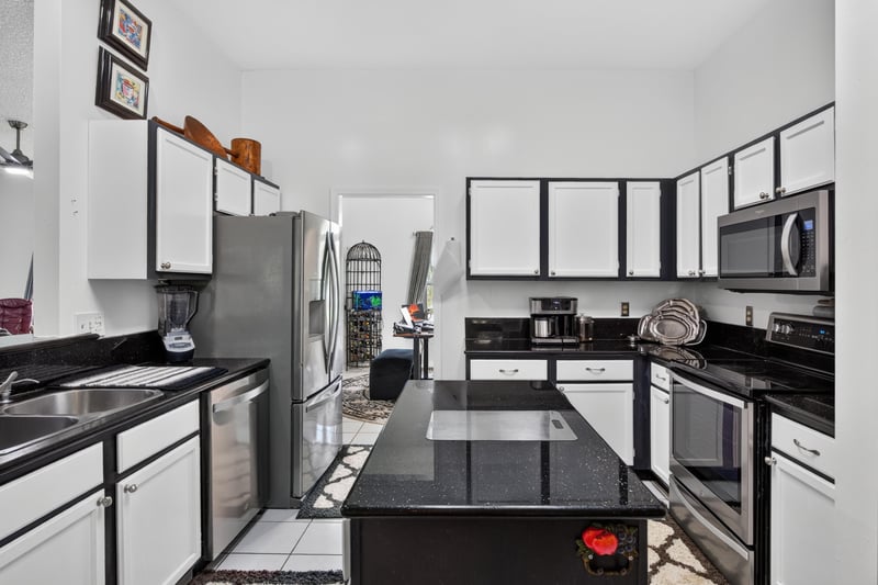Kitchen cabinetry and tile backsplash at 1346 Gately Ct, Jacksonville, FL 32225