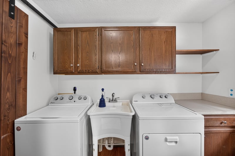 Laundry room with cabinets, washer and dryer at 892 Branscomb Rd, Green Cove Springs, FL