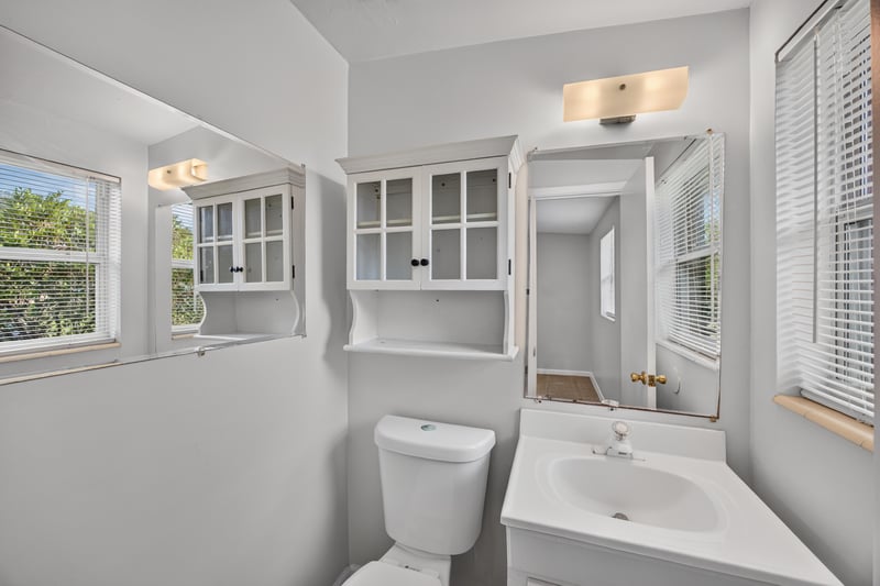 Bathroom sink and mirror with window at 87 Saratoga Cir S, Atlantic Beach, FL
