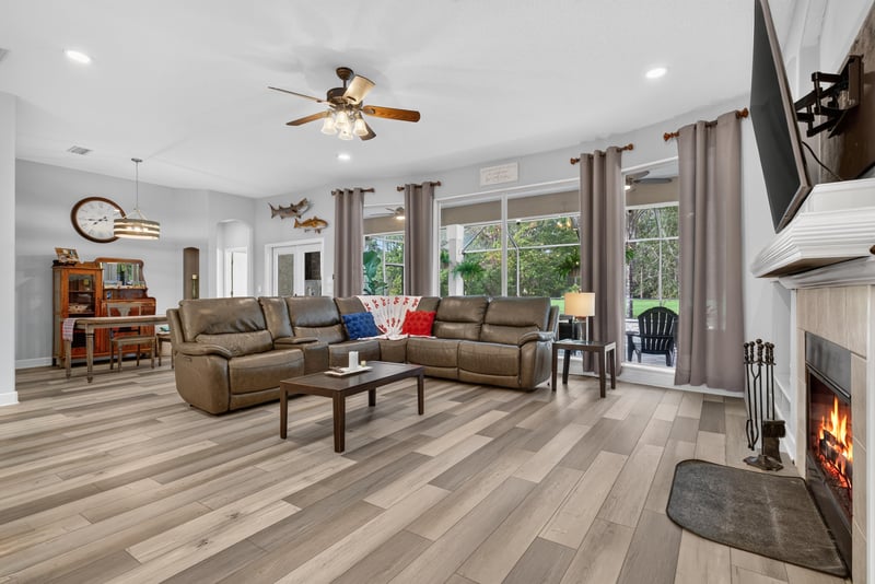 Living room with fireplace and ceiling fan at 2304 Spring Hill Ct, Orange Park, FL
