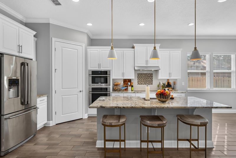 Kitchen island with bar seating and stainless appliances at 3328 Southern Oaks Dr, Green Cove Springs, FL 32043