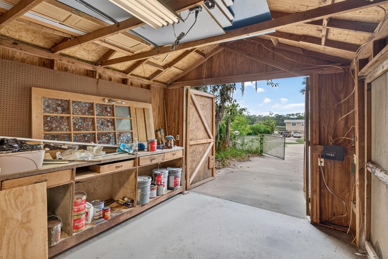 Workshop interior with storage shelves and open door at 217 Baisden Rd, Jacksonville, FL 32218