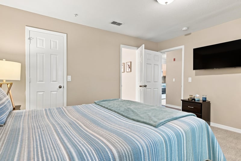 Bedroom with bed and nightstand lamps at 7800 Point Meadows Dr, Jacksonville, FL 32256