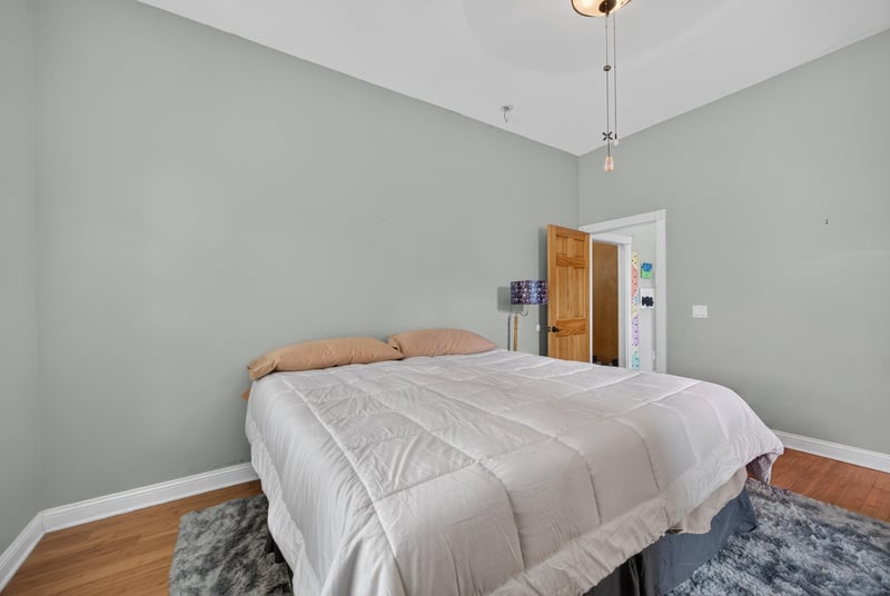 Bedroom with bed and hardwood floors at 1735 Hagans Ridge Ct