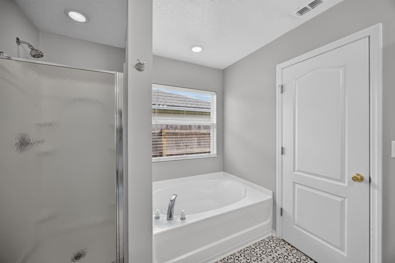 Bathroom with soaking tub and shower at 7545 Lirope St, Jacksonville, FL 32244