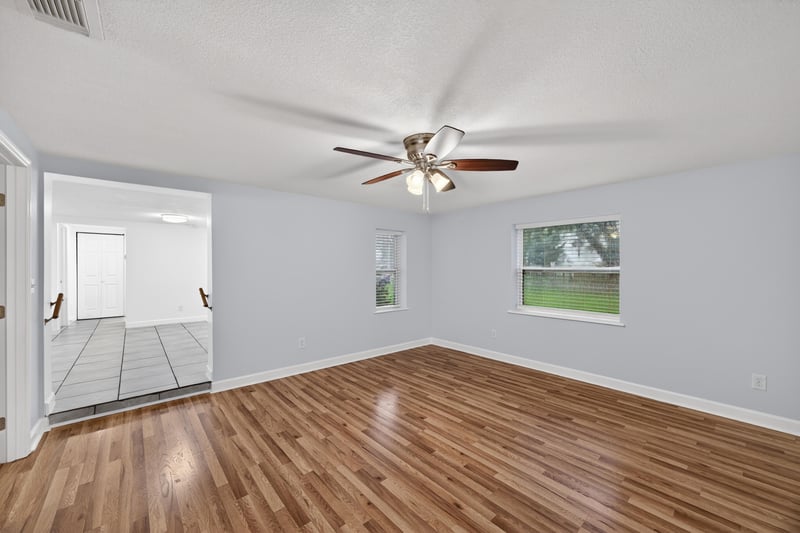 Empty room with wood floors opening to hallway at 1619 Hammond Blvd, Jacksonville, FL