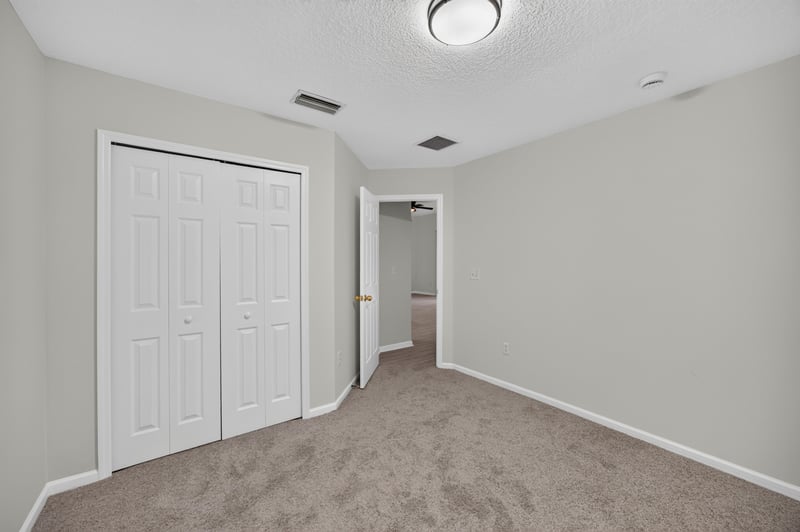 Hallway with closet doors at 706 Bonaparte Dr, Jacksonville, FL 32218