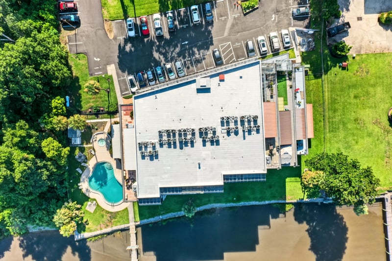 Aerial close view of pool and building roof in Jacksonville