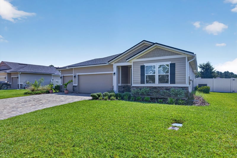 Front exterior with lawn and driveway at 855 Flach Dr, St. Johns, FL