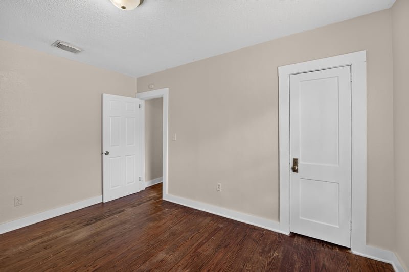 Empty room with wood floors and closet door at 1473 State St W, Jacksonville, FL 32209