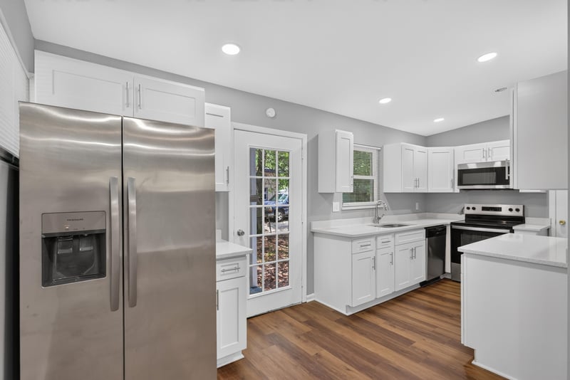 Kitchen with stainless refrigerator and white cabinets at 1928 Montmarte Dr, Jacksonville, FL 32210