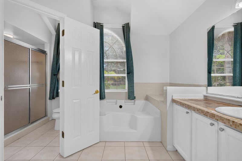 Primary bathroom closet doors and hallway at 12810 Swamp Owl Ln