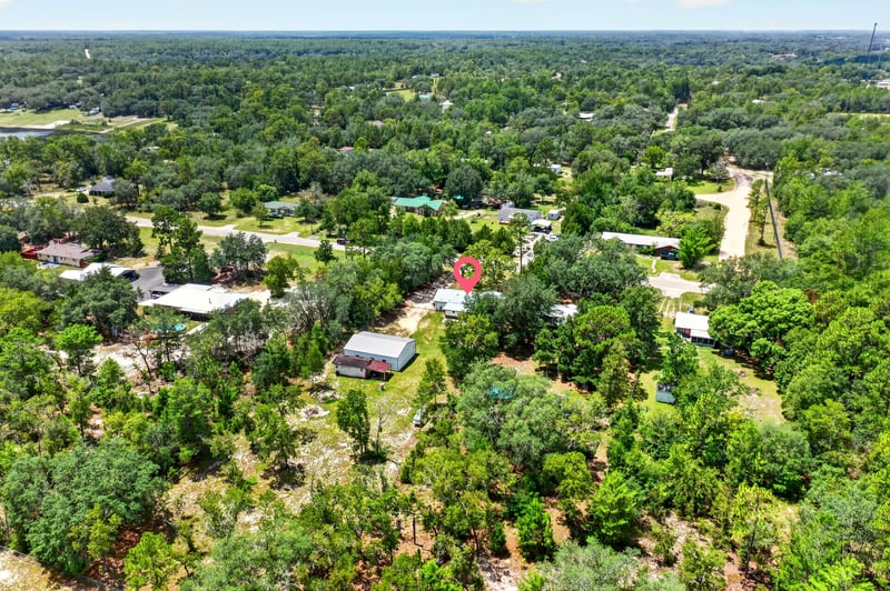Aerial view of surrounding neighborhood and tree canopy in Keystone Heights, FL