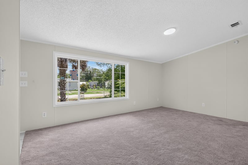 Living room with large window, unfurnished at 7603 Coach Park Dr, Jacksonville, FL 32244