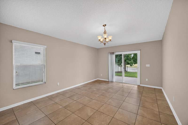 Living room with chandelier and tile floor at 469 Glendale Ln, Orange Park, FL