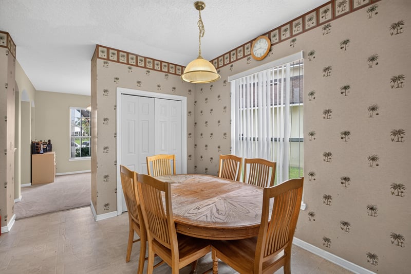 Dining room with wallpaper border and table at 2875 Pebblewood Ln, Orange Park, FL 32065
