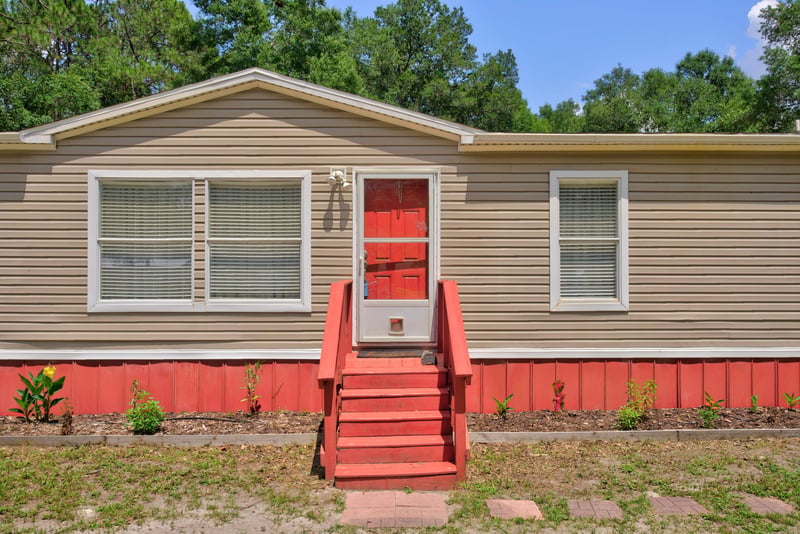 Close view of front door and red staircase at 2549 Snapdragon Ave, Middleburg, FL 32068