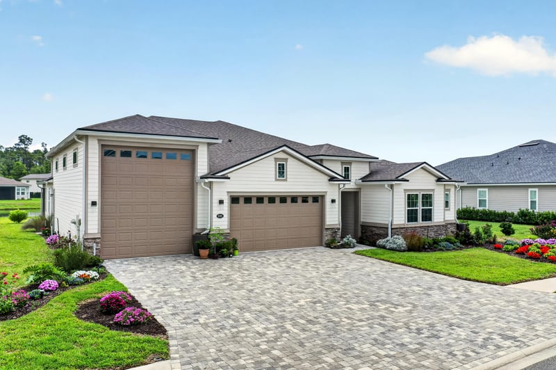 Front exterior with garage doors and curved driveway at 85491 Fall River Pkwy, Fernandina Beach, FL 32034