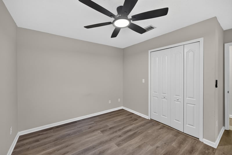 Bedroom with double closet doors at 7723 Playschool Ln, Jacksonville, FL